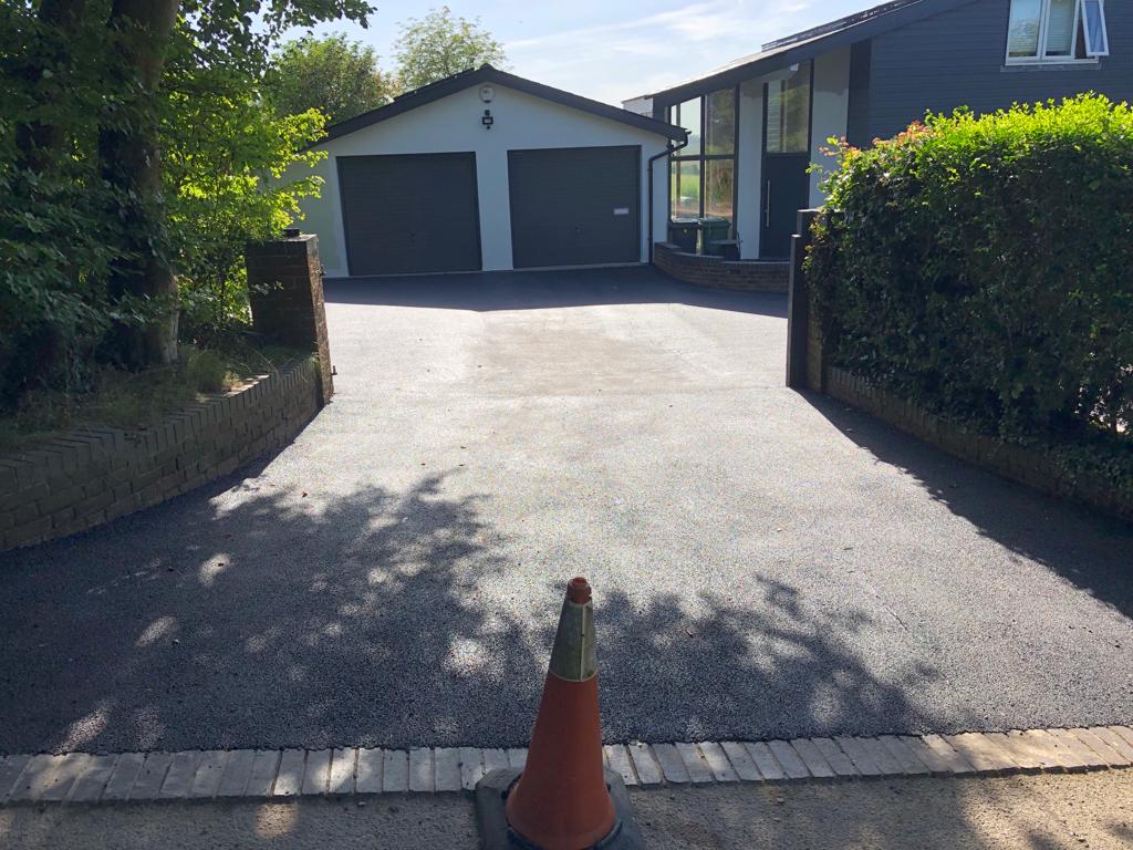 This is a photo of a bitumen driveway which is in the process of being installed by Woodridge Surfacing Solutions
